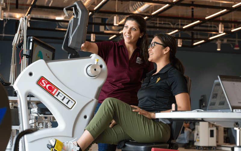 ASU professor and student working on gym equipment