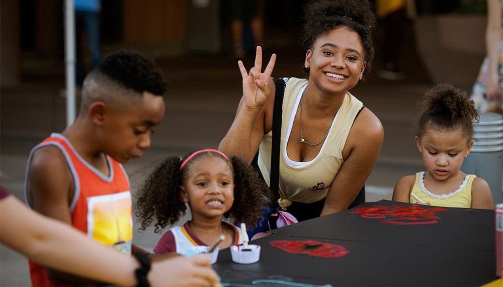 ASU student with her children participating in an event