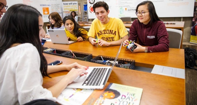 ASU students sitting in a classroom and talking together