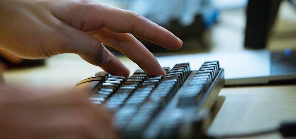 Fingers typing on keyboard