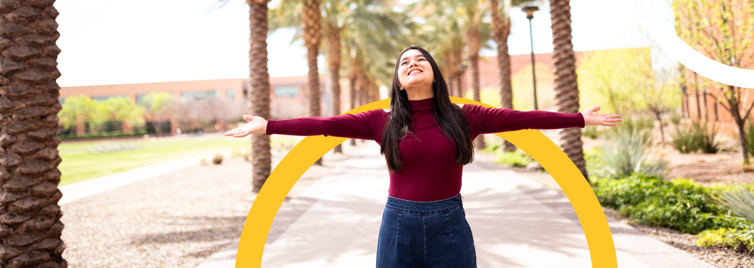 ASU woman looking up at the sky and standing on campus