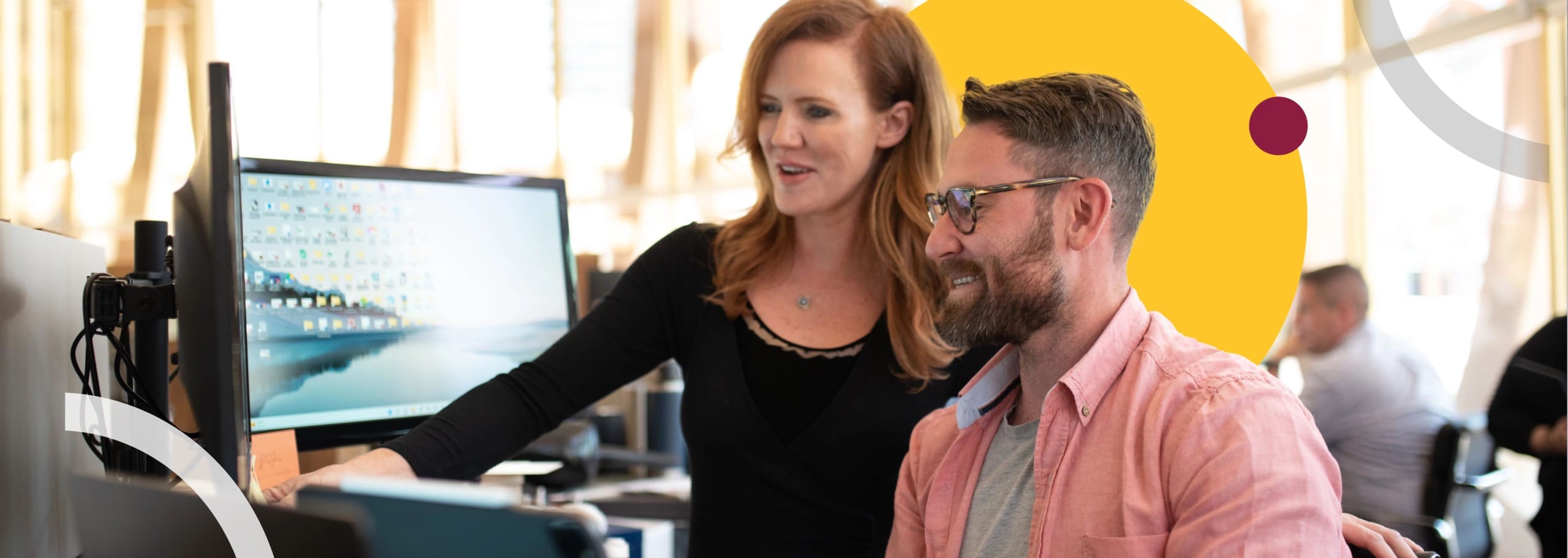 Man and woman looking at a computer monitor