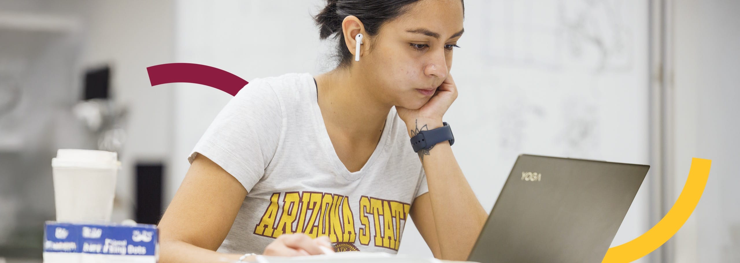 ASU woman thinking and looking at laptop